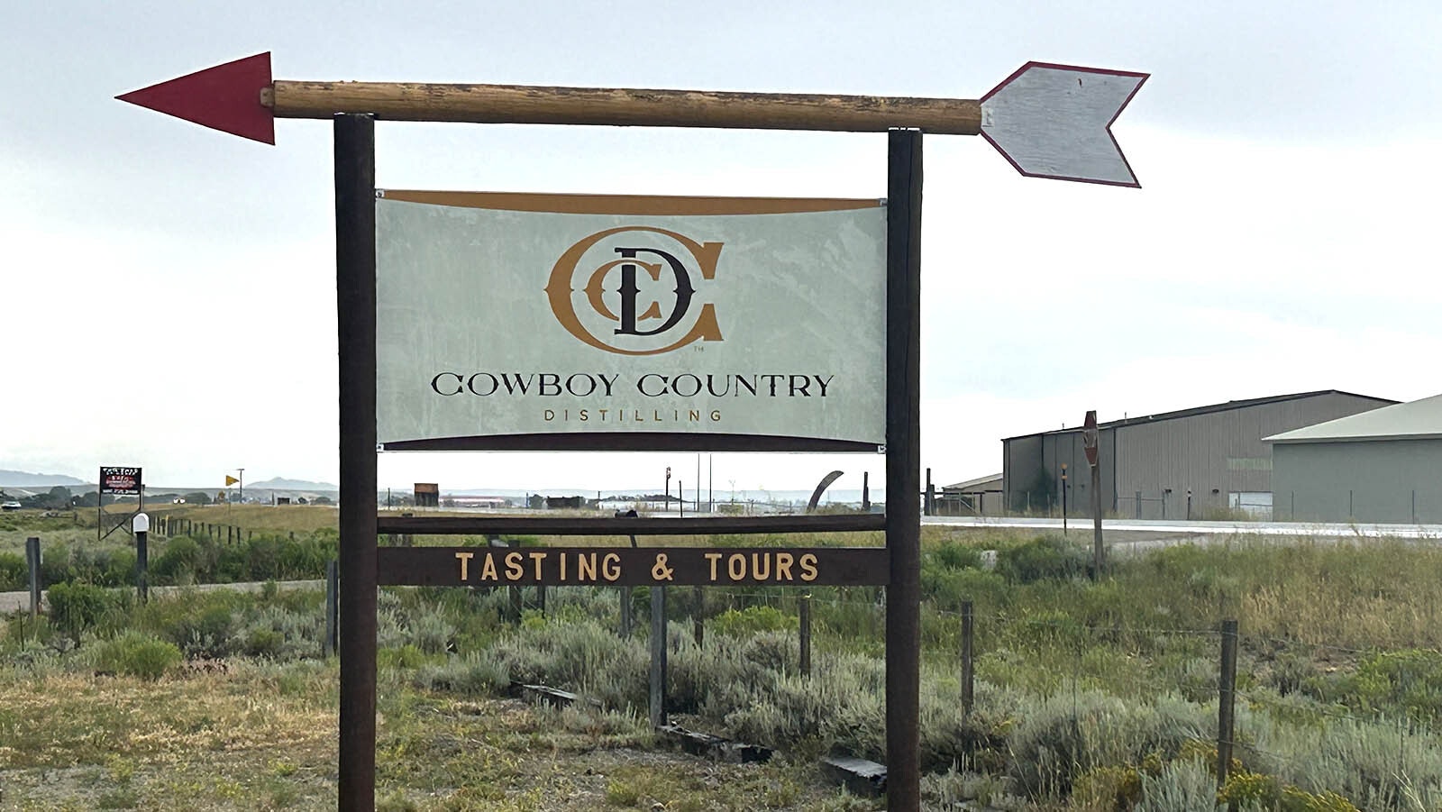 A sign shows travelers the entrance to Cowboy Country Distilling.