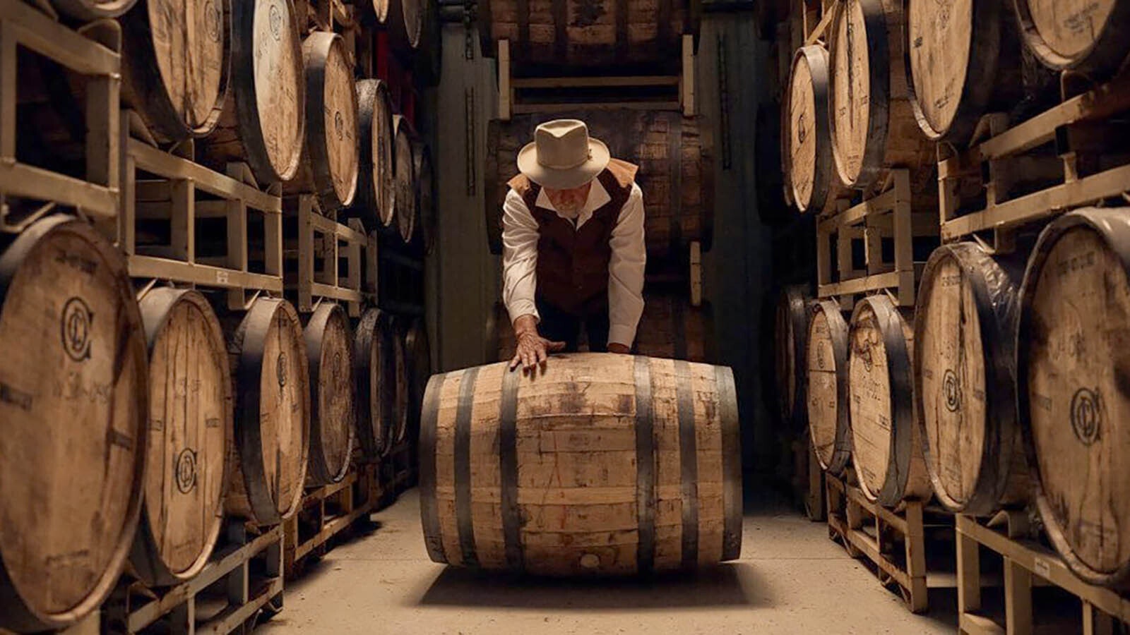 Tim Trites rolls a barrel of spirits at his distillery outside Pinedale.