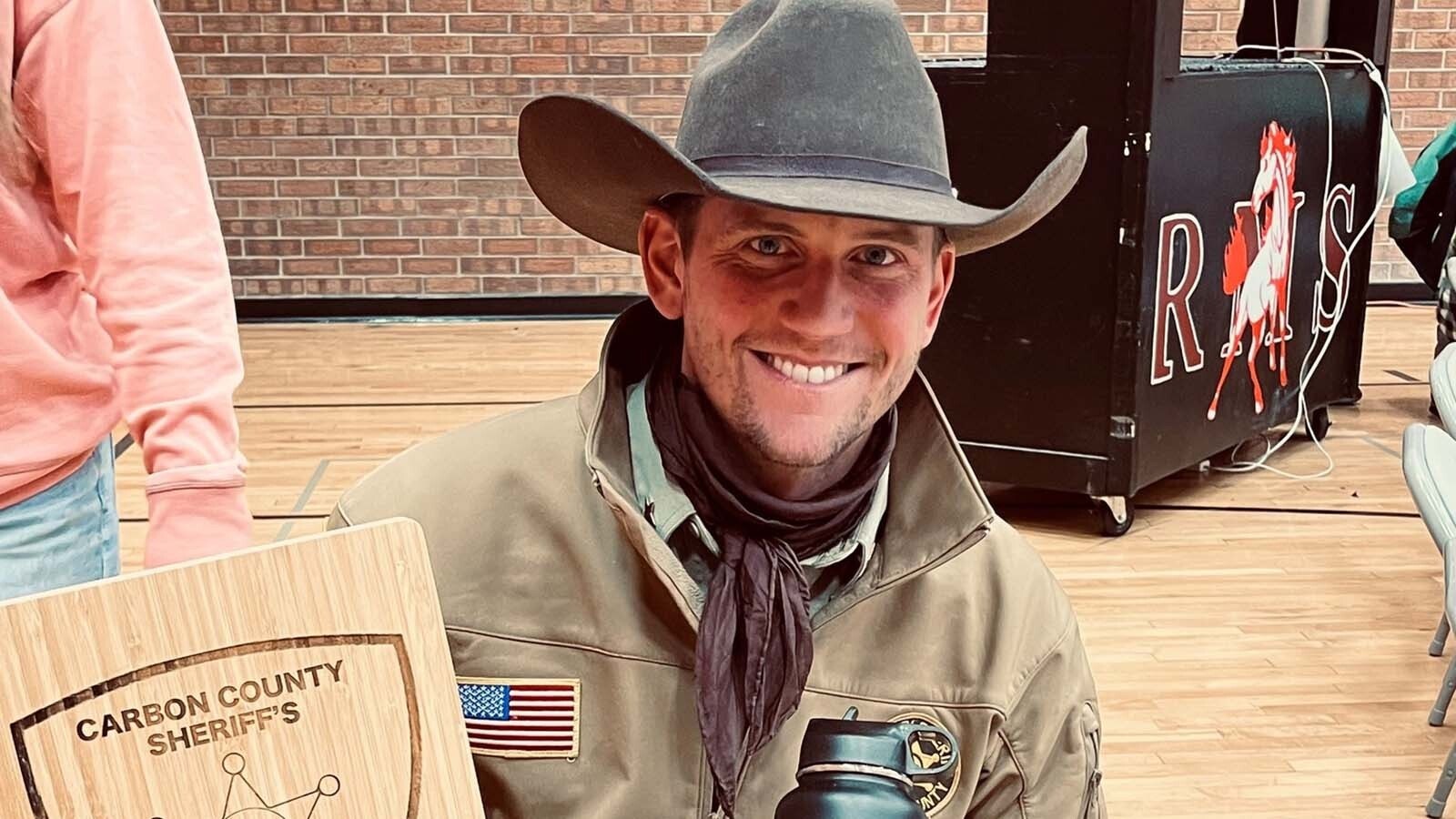 Carbon County Sheriff Alex Bakken in uniform with a cowboy hat.