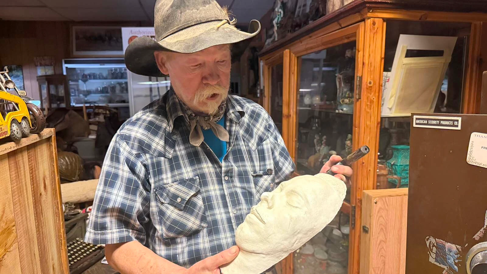 ohn Fremlin keeps his most valuable items in his antique store in his safe which includes the death mask and hand-carved gun of John Dillinger, a bank robber and murderer, who escaped from prison in the 1930s before being gunned down. Fremlin is constantly on the lookout for treasures such as this for his antique store in Meeteetse.