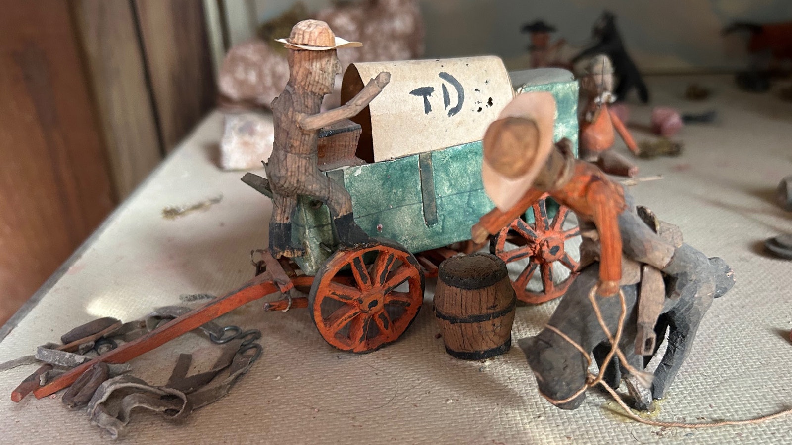 A cowboy tries to stay on his mount in a scene created by Bill Evans.