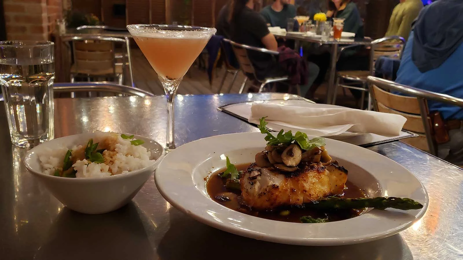 The Miso sea bass, right, is flown in overnight from Seattle, making it almost like fresh caught. It is perfectly prepared, and served here with rice and a signature cocktail from the Cowfish restaurant.