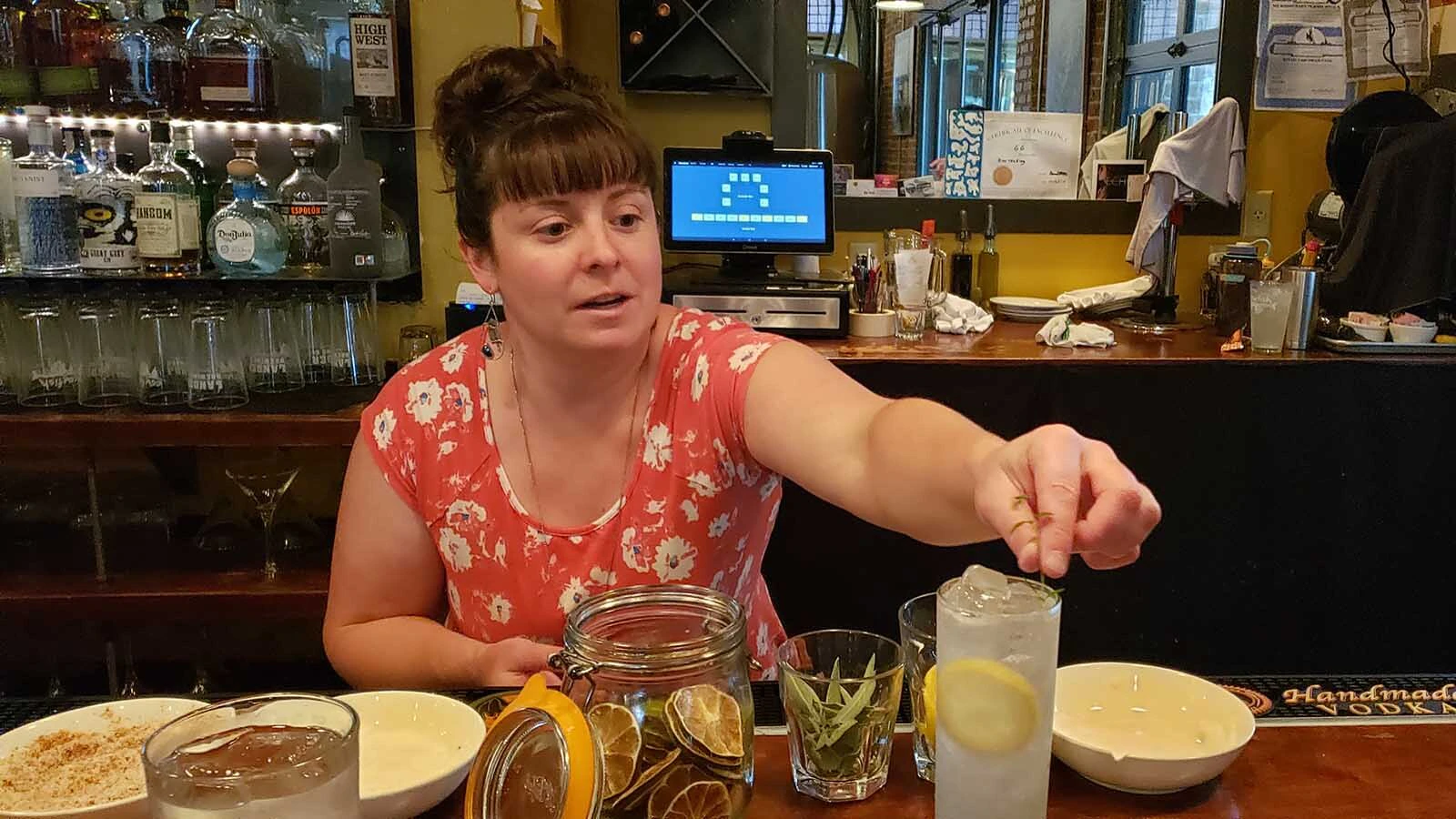 A bartender at the Cowfish garnishes a freshly made cocktail during the dinner rush.