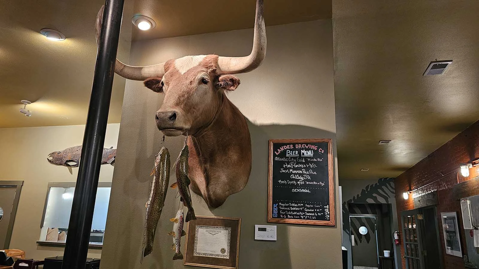 Art on the walls at the Cowfish echoes the legend printed on its menu, about a strange half cow, half fish creature.