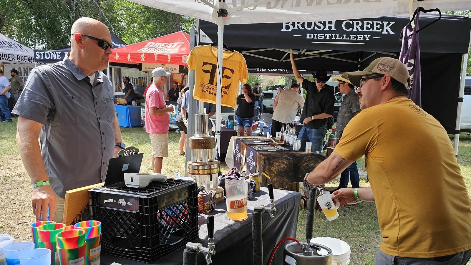 Eric Killmer with Freedom's Edge Brewing pours a sample for a customer during the Steinley Cup in Saratoga. Many brewers feel the craft brew industry is becoming saturated.