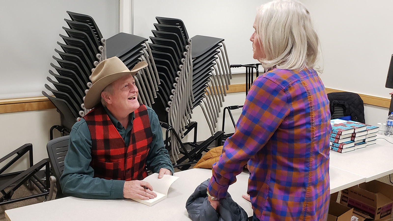 Craig Johnson has a laugh and a smile for everyone waiting in line to have a book signed. He takes his time with each one, telling jokes and stories until they're smiling right along with him.