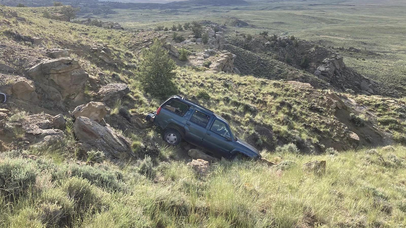 This GMC Yukon that sits crashed and abandoned in rugged terrain off Highway 14-16-20 in northwest Wyoming sparked a lot of speculation. Truth is, a suspected drunk driver left it there.