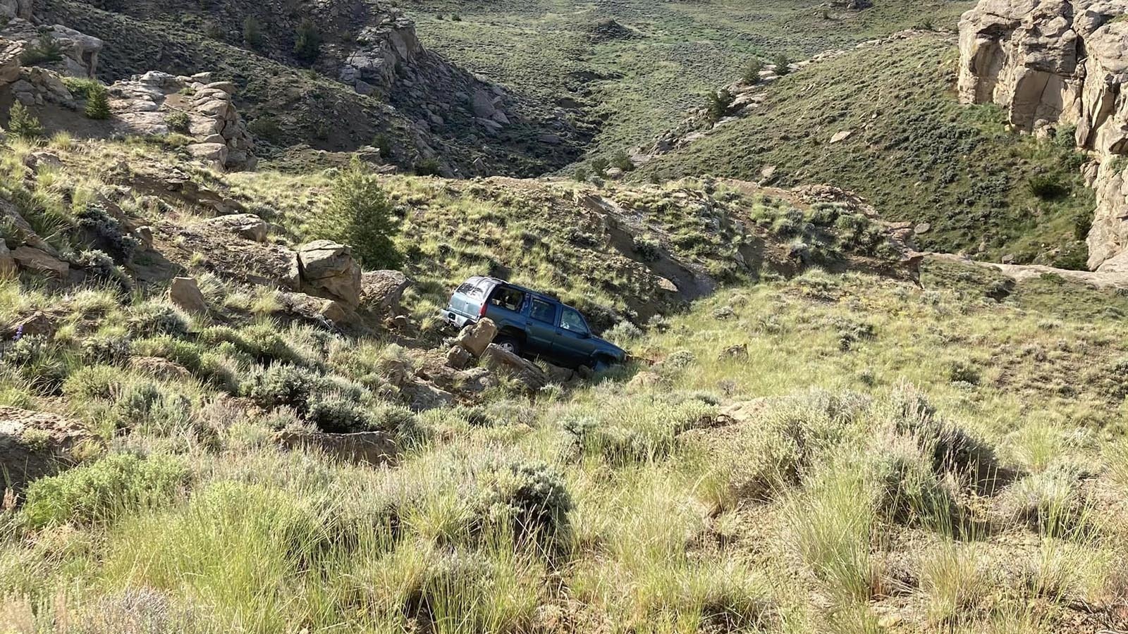 This GMC Yukon that sits crashed and abandoned in rugged terrain off Highway 14-16-20 in northwest Wyoming sparked a lot of speculation. Truth is, a suspected drunk driver left it there.