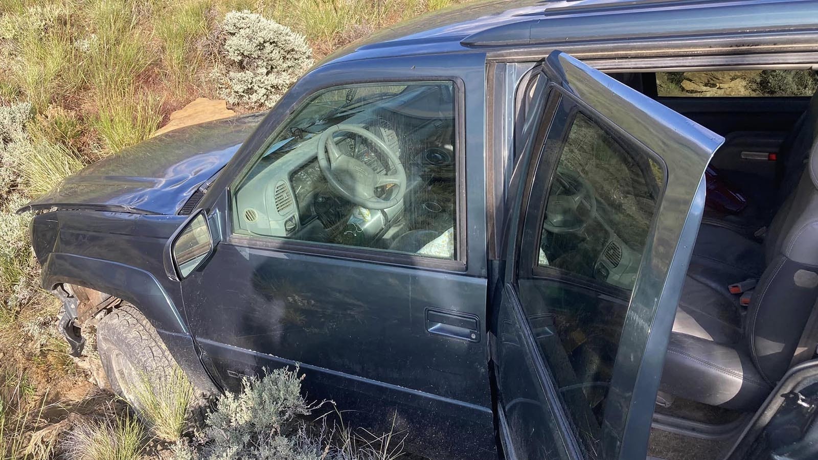 This GMC Yukon that sits crashed and abandoned in rugged terrain off Highway 14-16-20 in northwest Wyoming sparked a lot of speculation. Truth is, a suspected drunk driver left it there.