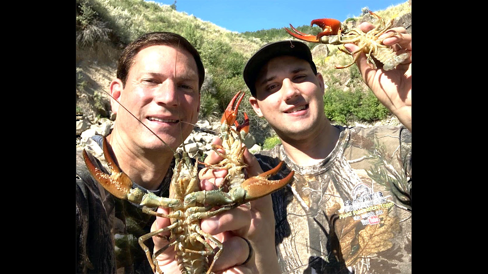 Mike Burell and his son Jake show some crayfish they caught in eastern Idaho. Burrell says Wyoming is a great place to catch crayfish too.