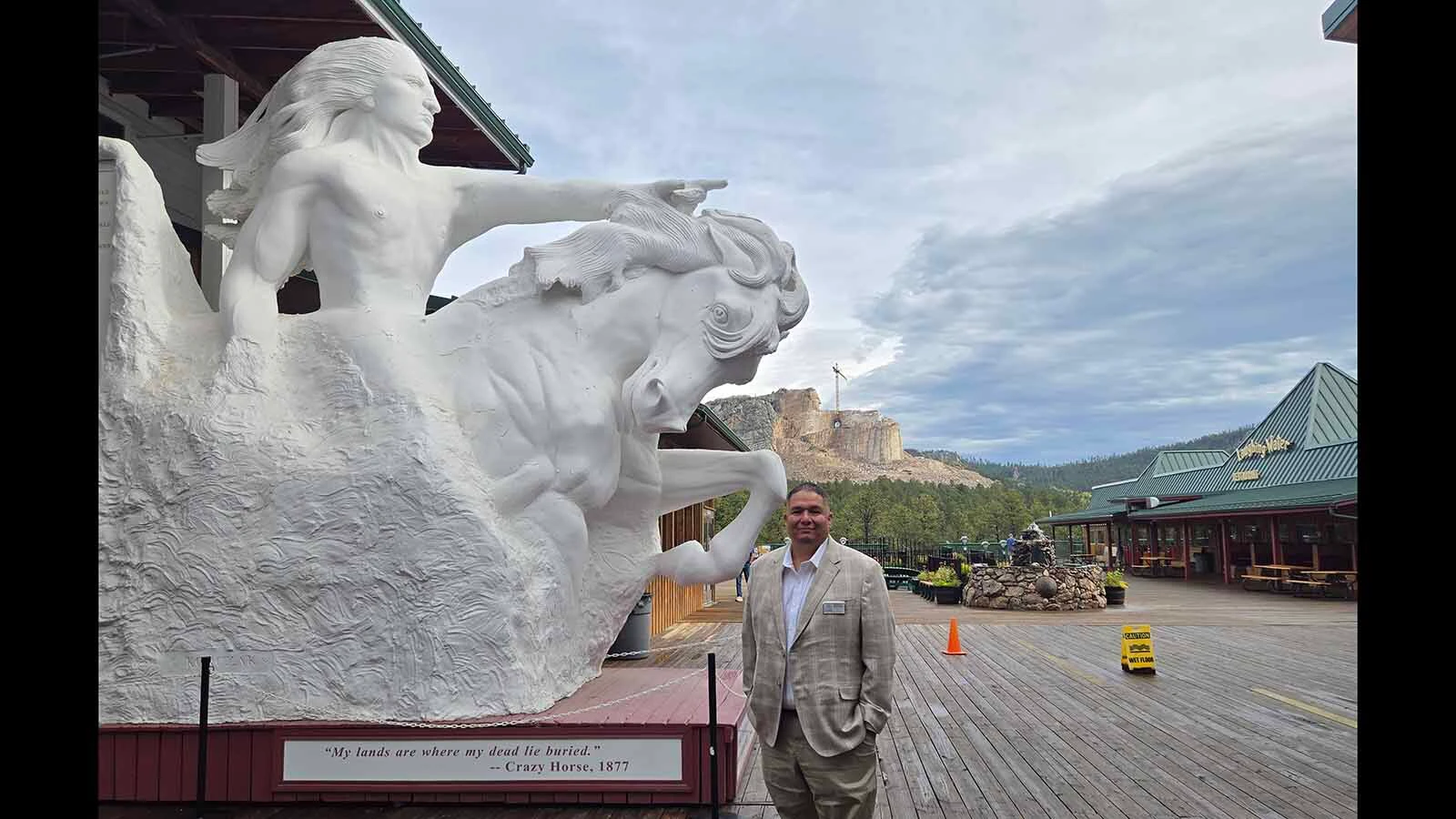 Whitney Rencountre in front of a finished model showing what the mountain carving will look like.