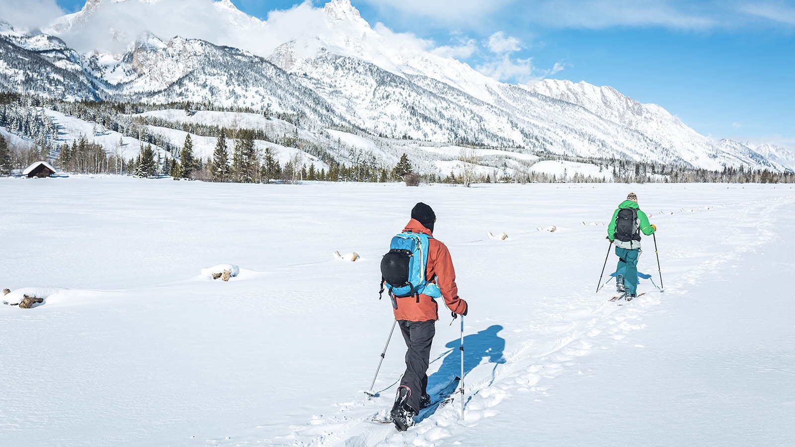 A pair of cross-country skiers enjoy a day near the base of the Grand Tetons in northwest Wyoming.