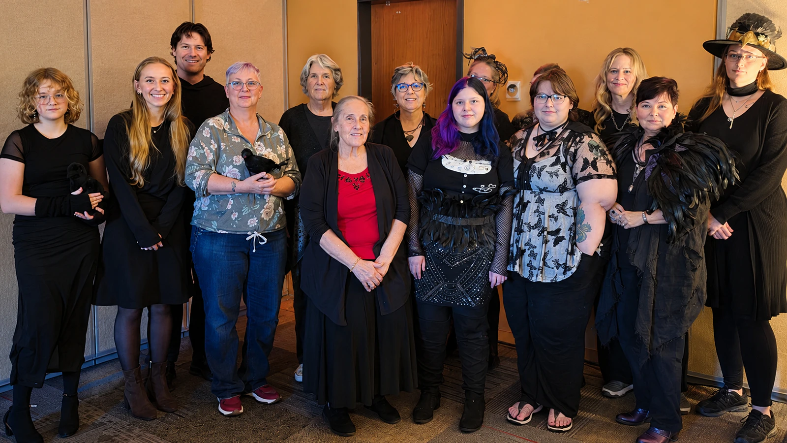 Attendees of the tea party dress in black, feathers and crow-inspired attire Sunday in Douglas. 