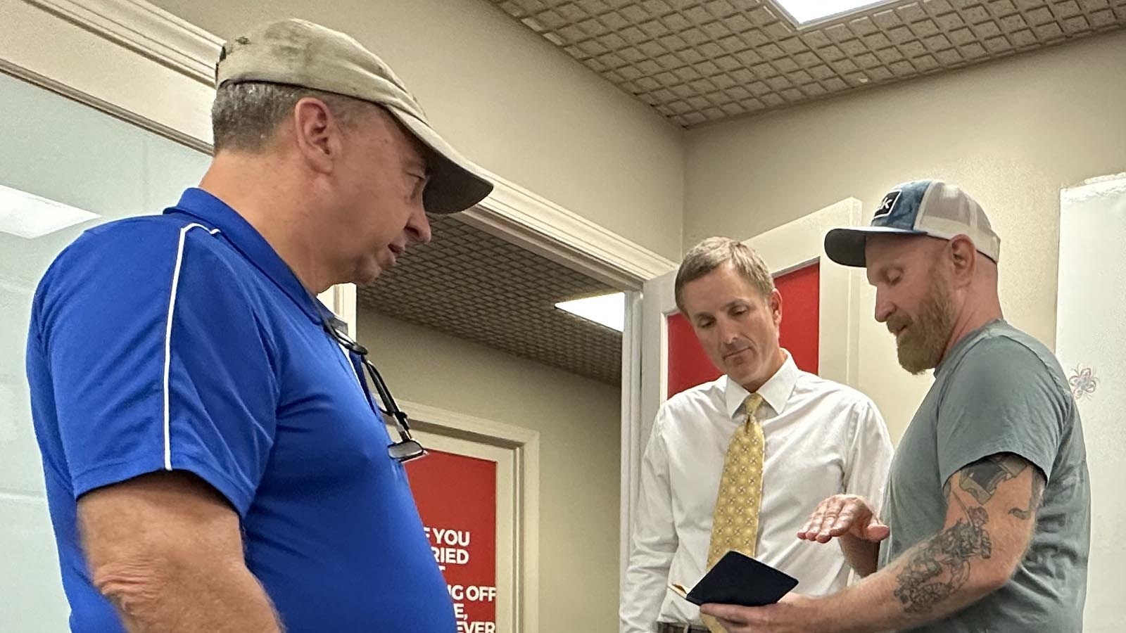 Dan Gyder and Rick, son of Richard McCoy II, meet with an FBI agent in Richmond, Virginia, in Sept. 2023 to hand over McCoy's parachute and skydiving logbook.