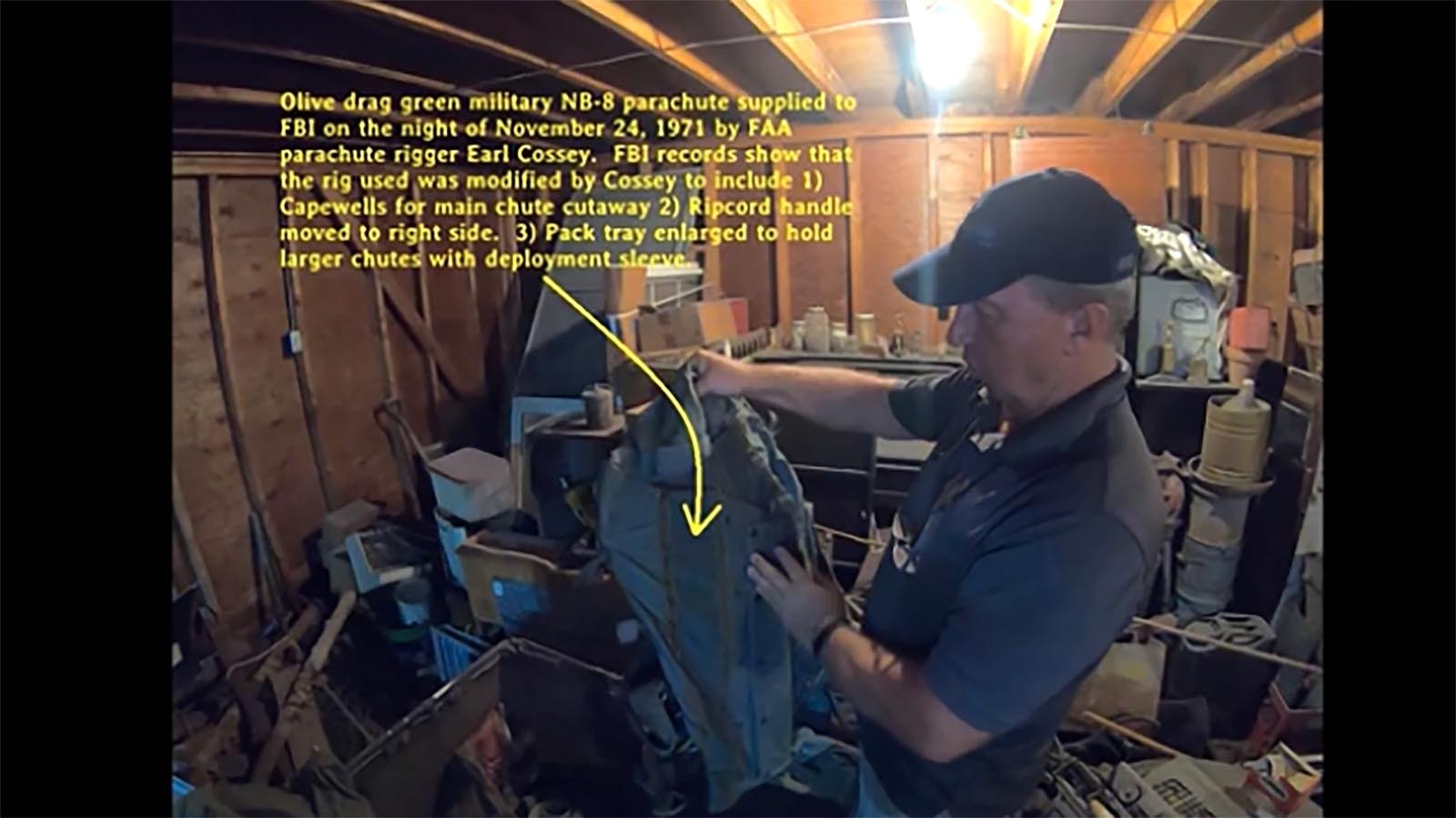 Dan Gryder describes the modifications to the military-issued NB-8 parachute including the moving of the ripcord handle from left side to right, cut straps, added D ring attachments, and enlarged the pack tray made by Earl Cossey, the skydiver who provided the four parachutes to D.B. Cooper during the hijacking.