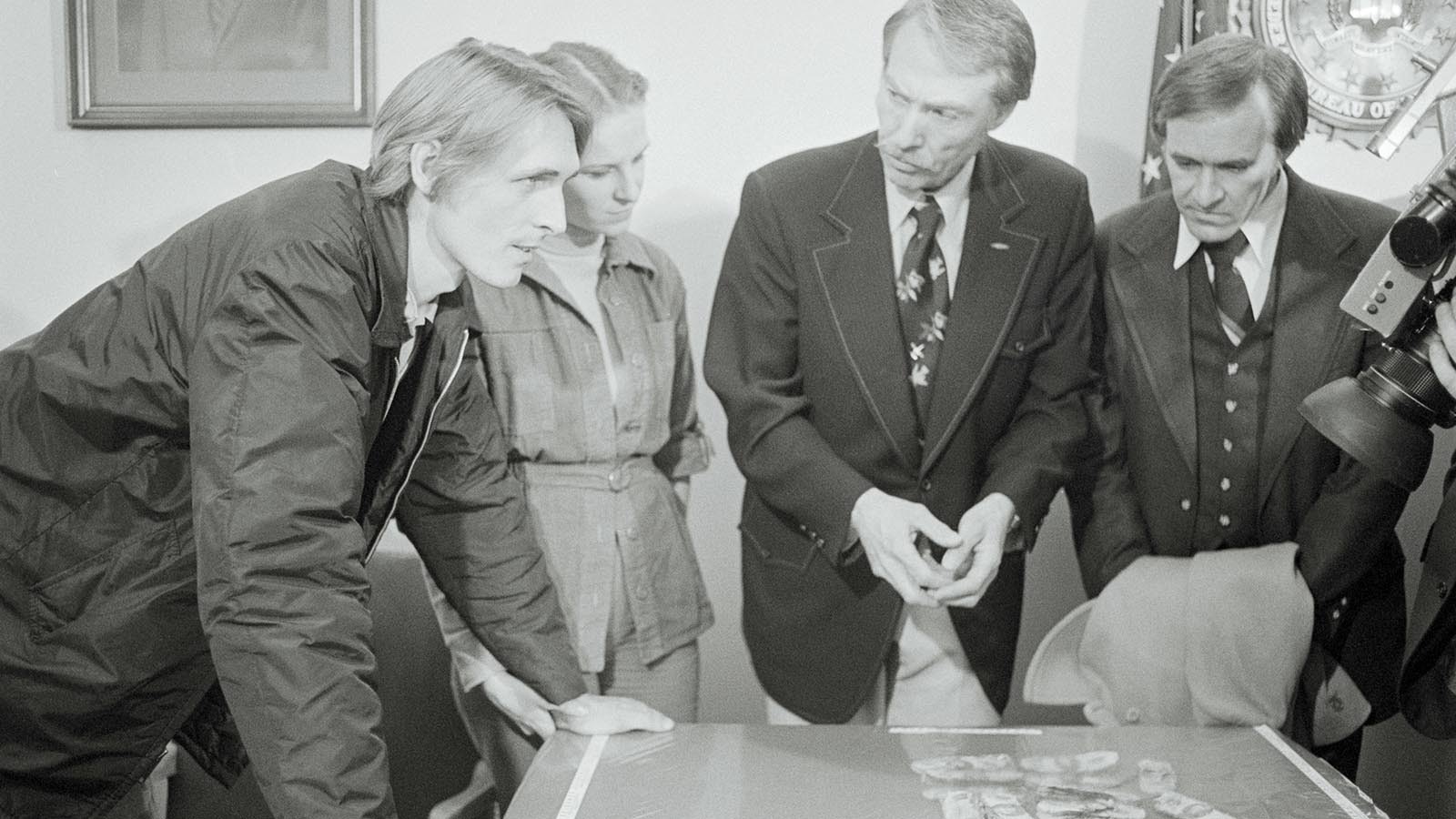 FBI agent Ralph Himmelsbach, second from right, asks questions of Mr. and Mrs. Harold Dwayne Ingram, left, at FBI offices where it was announced that the Ingram's son Brian, 8, had found the D.B. Cooper hijacking money while on family outing on the north shore of the Columbia River. Listening is William Wren, right, Northwest Orient Airlines, whose jetliner was hijacked by Cooper on Nov. 24, 1971.