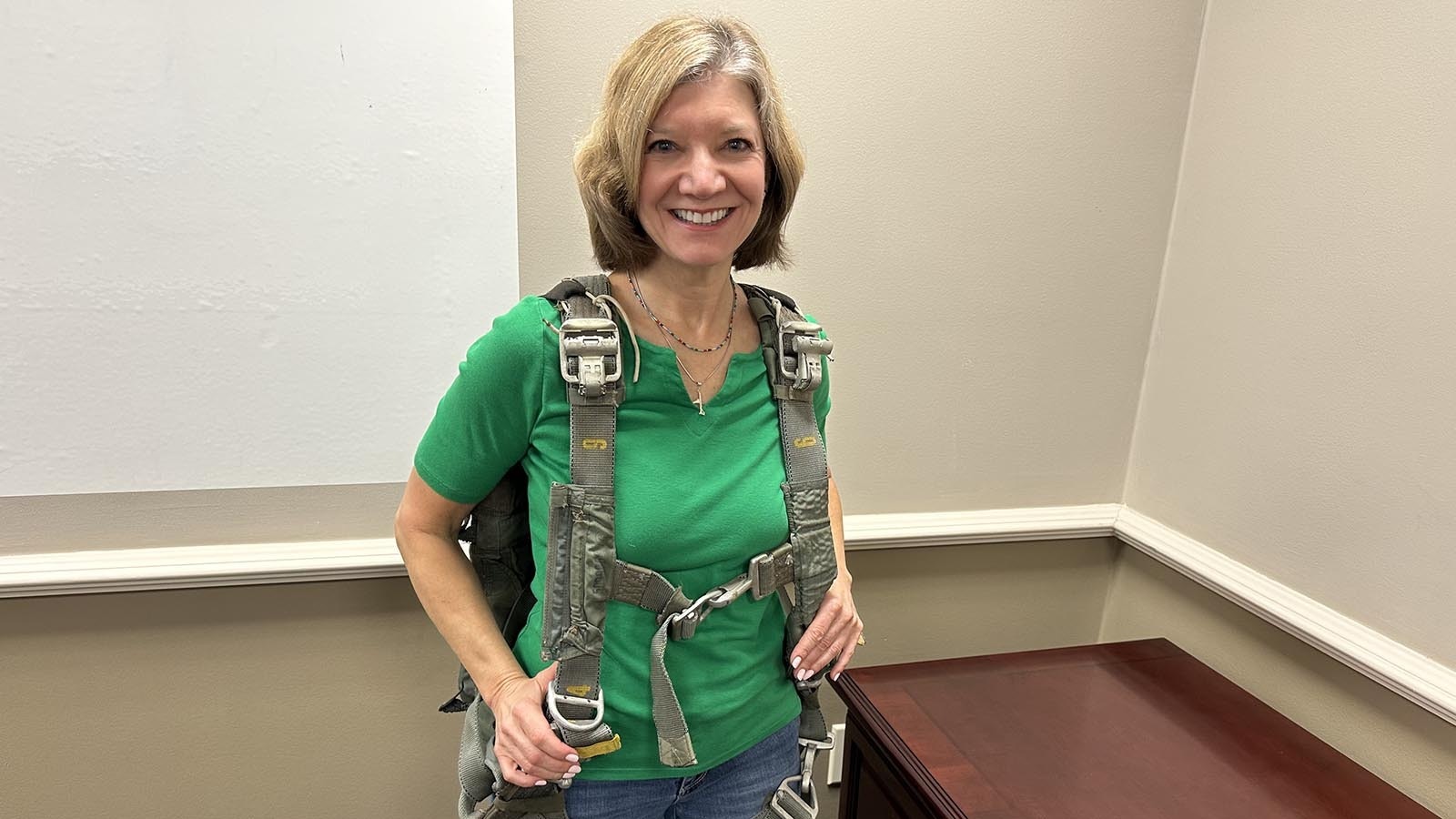 Pilot and author Laura Savino tries on the "one-in-a-billion" rig seized by the FBI in what might be the parachute used by D.B. Cooper.