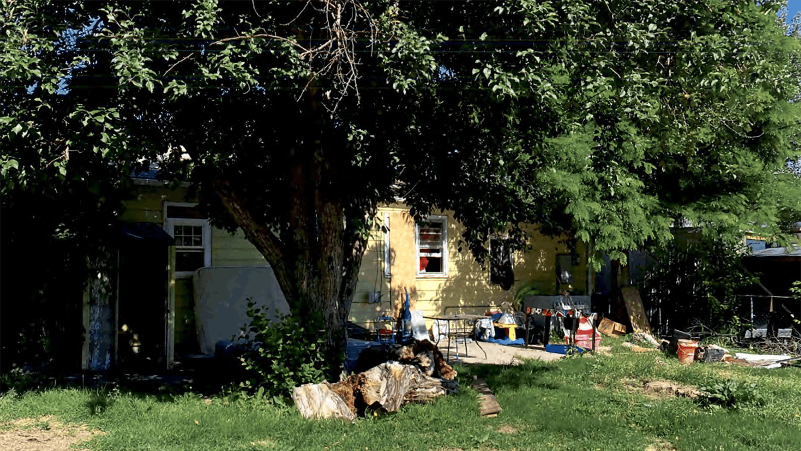The backyard of the former drug house was full of garbage and junk.