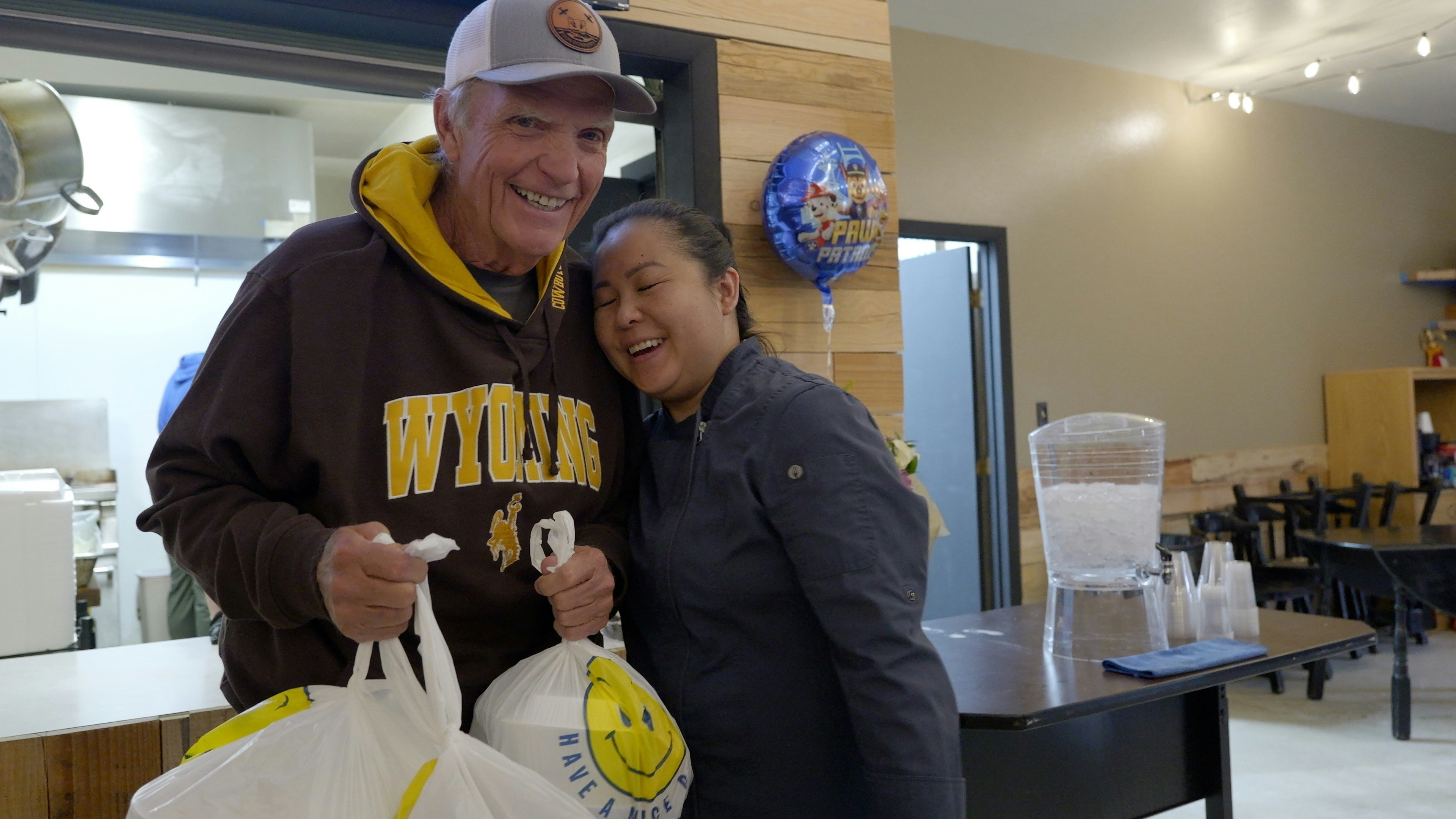 Vietnam War veteran Dave Soderquist greets KimChi Vu as he picks up his take out order from the V Cafe.