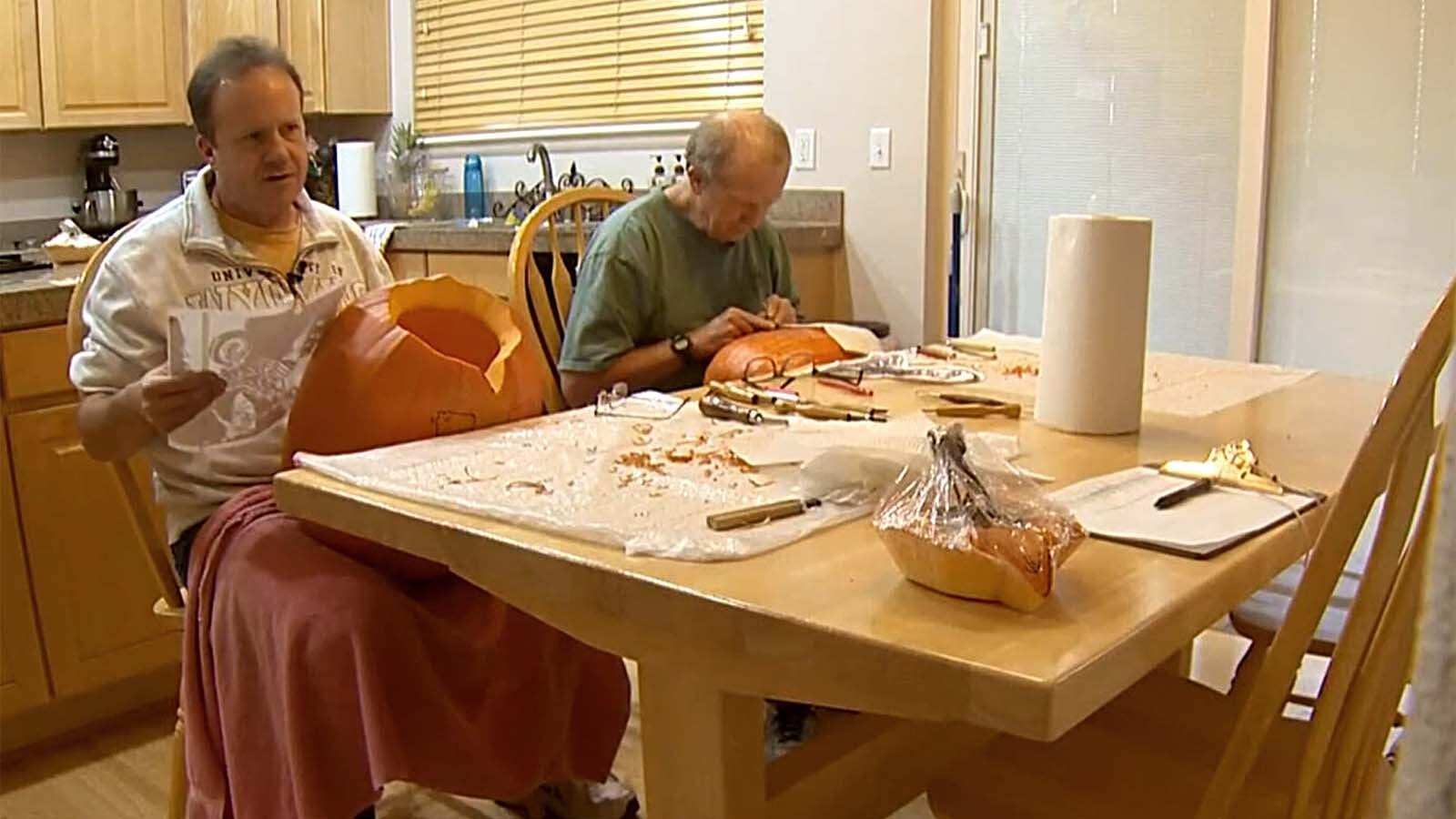 Dave, left, and older brother Greg Cunningham work to carve dozens of pumpkins.