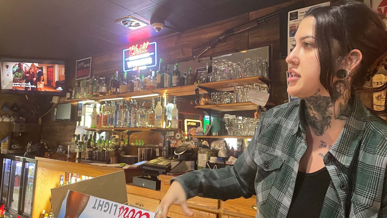 Erin, daytime bartender at the Bayou Bar in Mills, Wyoming, keeps the beers coming — whether the power's on or not.