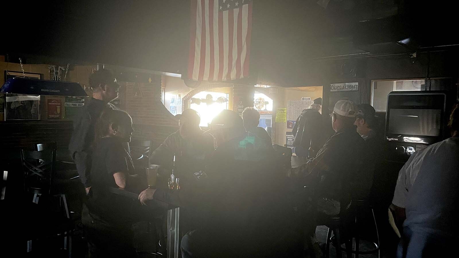 A power outage doesn't phase the day drinkers at the Bayou Bar in Mills, Wyoming.