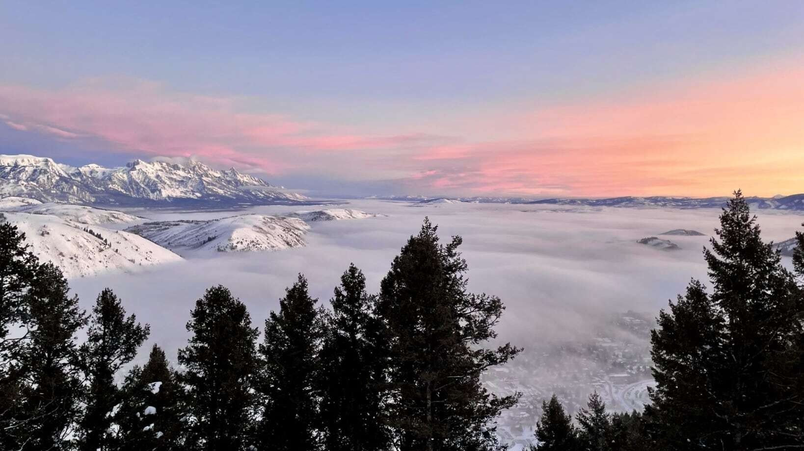 "The attached photo was taken this morning from the top of Snow King Mountain in Jackson, WY. My friend Greg and I skinned up for a sunrise descent and were treated to an especially spectacular display of color above the inversion. The ski down wasn't bad either!" Jackson, WY