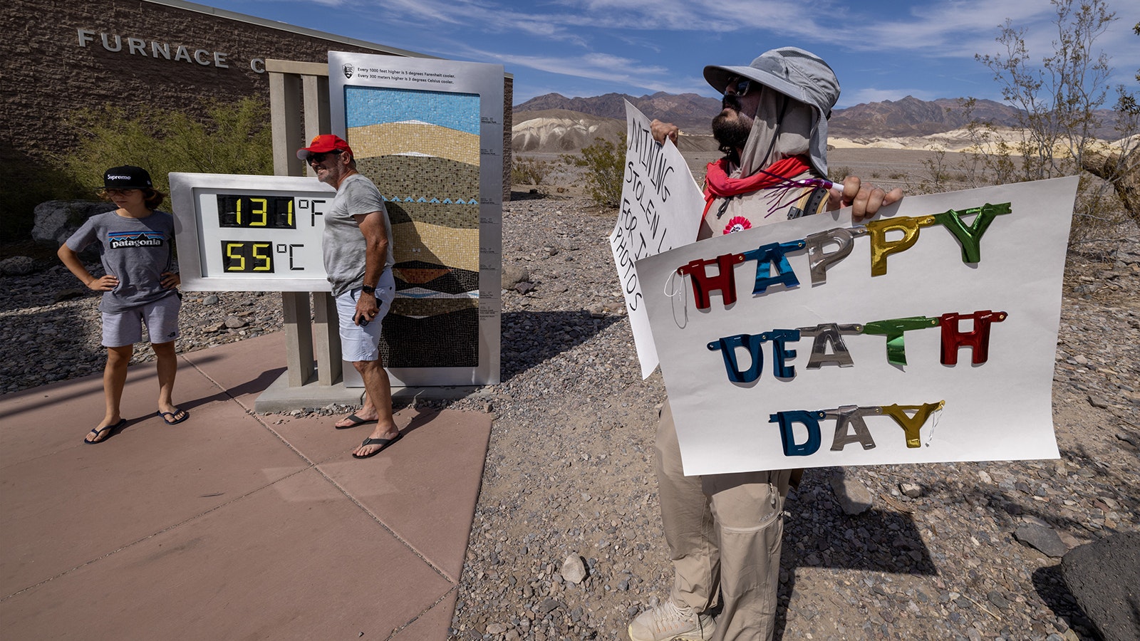 Tourists pose with a digital readout of the temperature in Death Valley, California, on July 16, 2023.