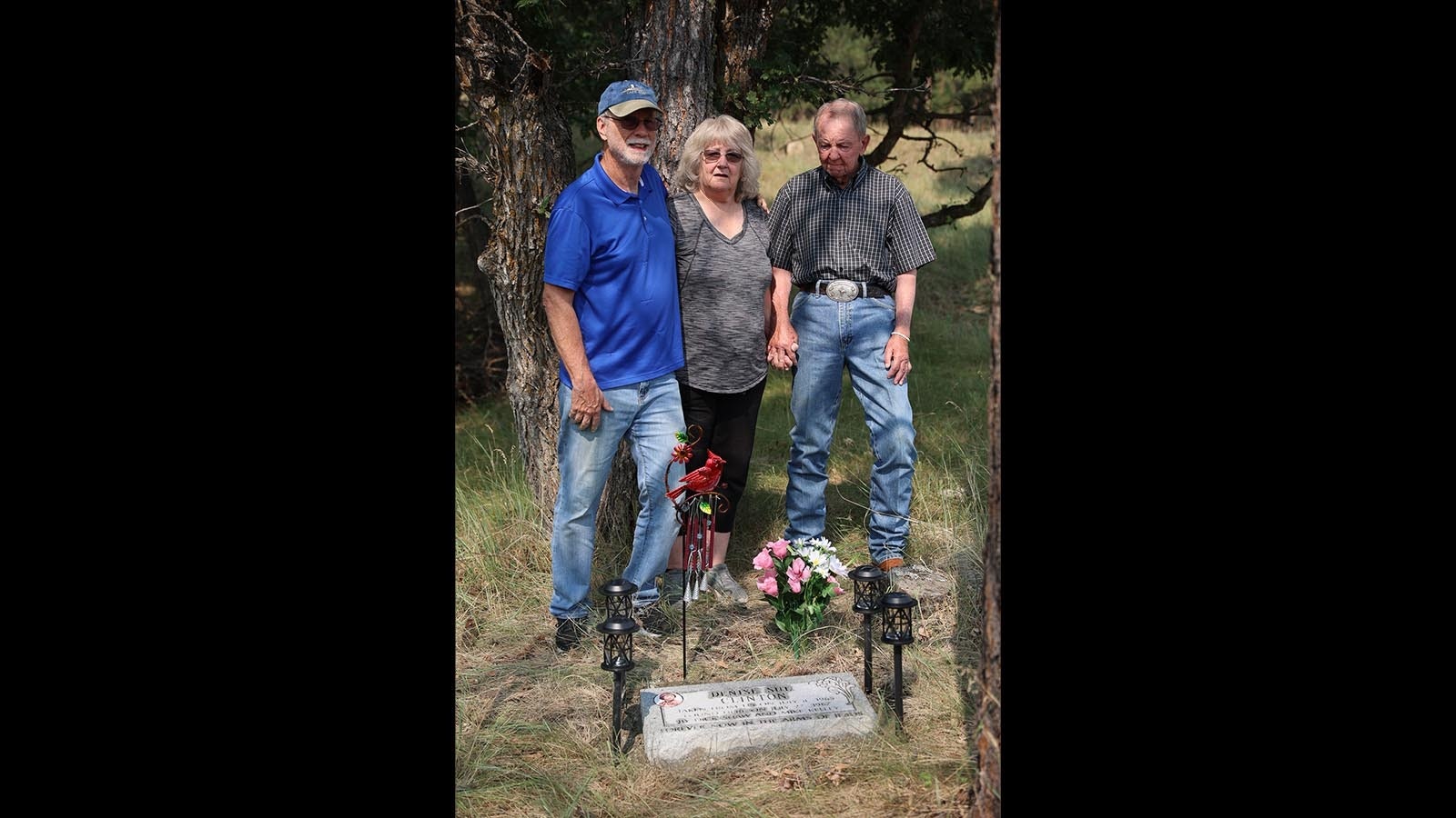 Diana White, 65, holds hands with Mike Kelly, 85, one of the two cowboys who found her sister's remains two years after she'd been abducted during a robbery at a Kansas motel.