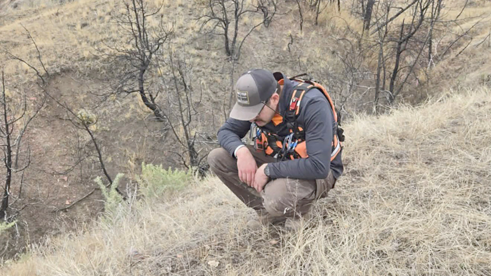 Charlie George Jr. of Carbon County West Search and Rescue studies an object on the ground as he searches Saturday.