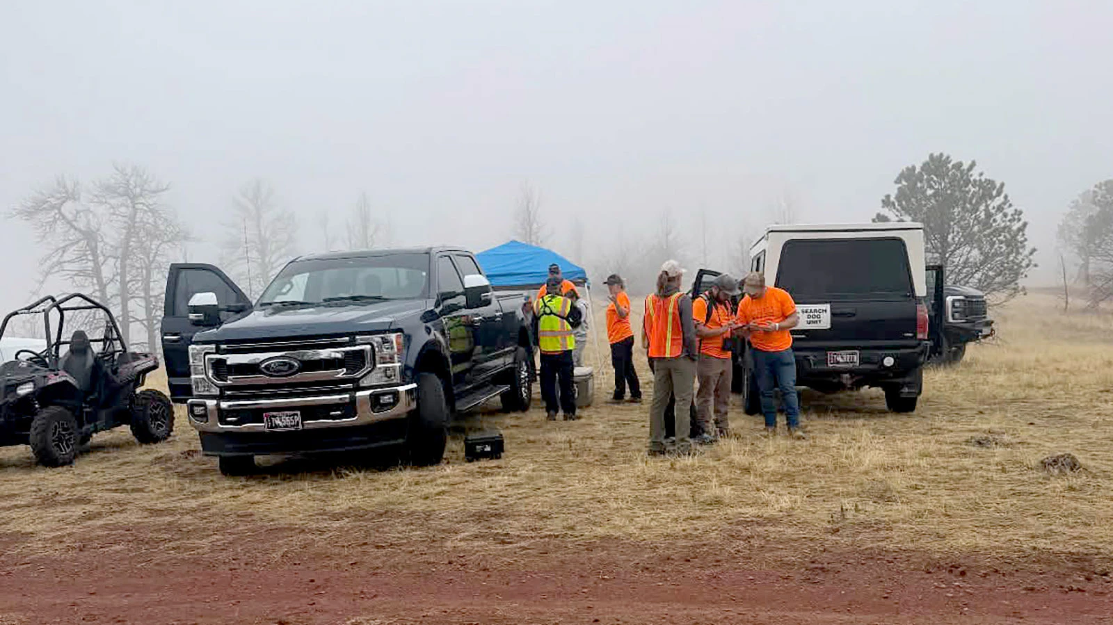 Searchers mull over CalTopo maps discussing search routes before heading out Saturday morning.