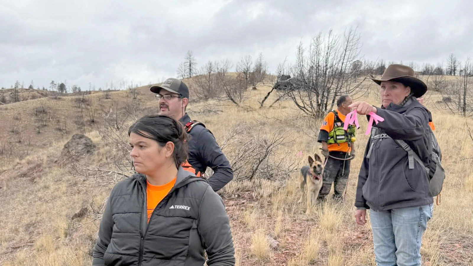 SAR team members help flag the route to the ravine where remains were discovered for law enforcement.