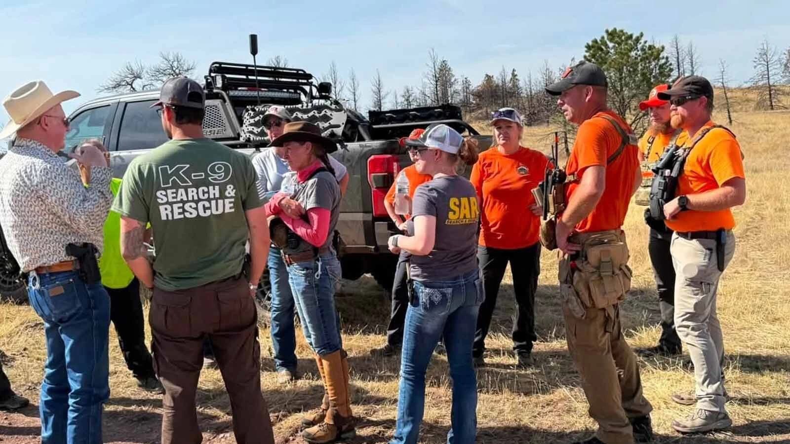 The search and rescue volunteers confer with Sgt. Sams of the Campbell County Sheriff's Office when his office came to retrieve the evidence they'd uncovered during the search on Aug. 17. 
