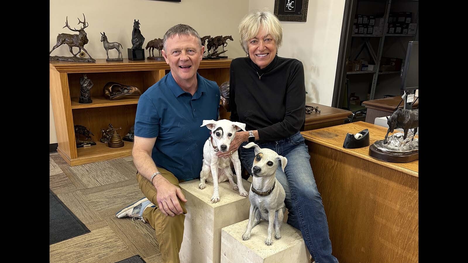 Harvey Deselms and bronze sculpture artist Christine Knapp show off the real and bronze versions of Dot, Deselms’ Jack Russell terrier. The bronze is in front.