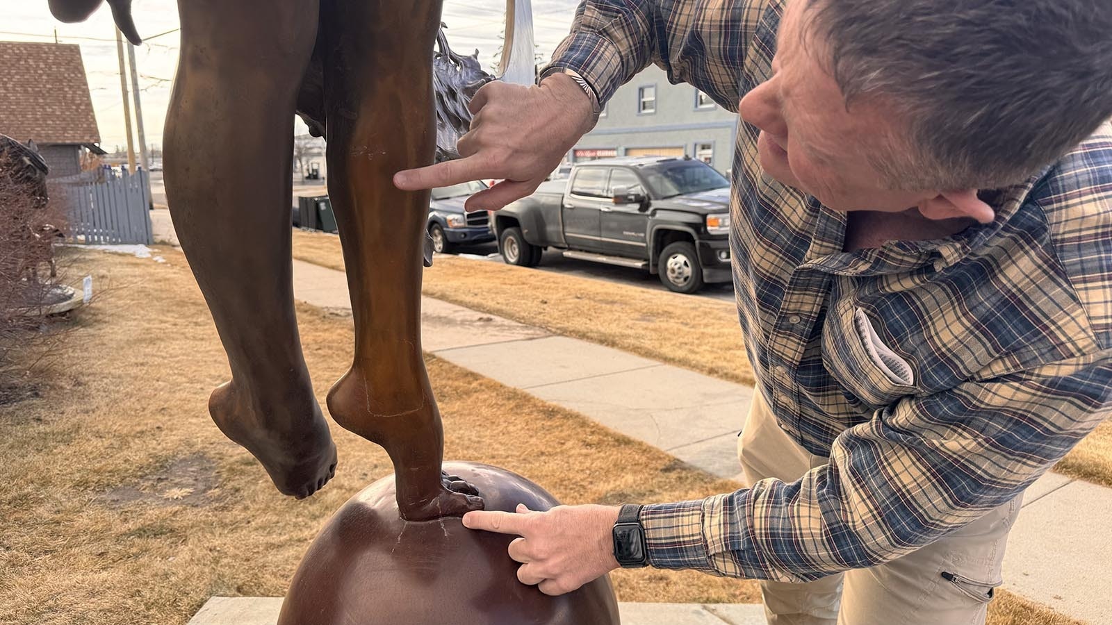 Harvey Deselms points to fractures in a sculpture title "Sunriser," which was hit by a truck Thursday, Jan. 16, 2025.