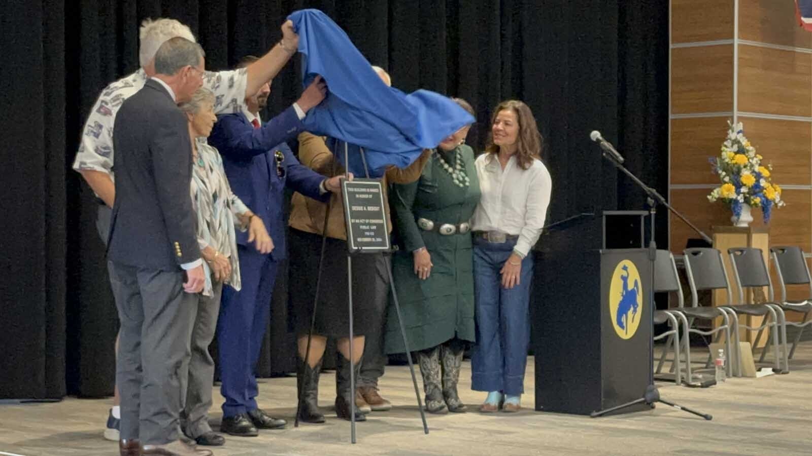 The plaque officially renaming the Shoshoni U. S. Post Office to the Dessie A. Bebout Post Office Building was unveiled on Wednesday in a dedication ceremony to honor the legacy of Dessie A. Bebout for her years as postmistress and her military and community service.