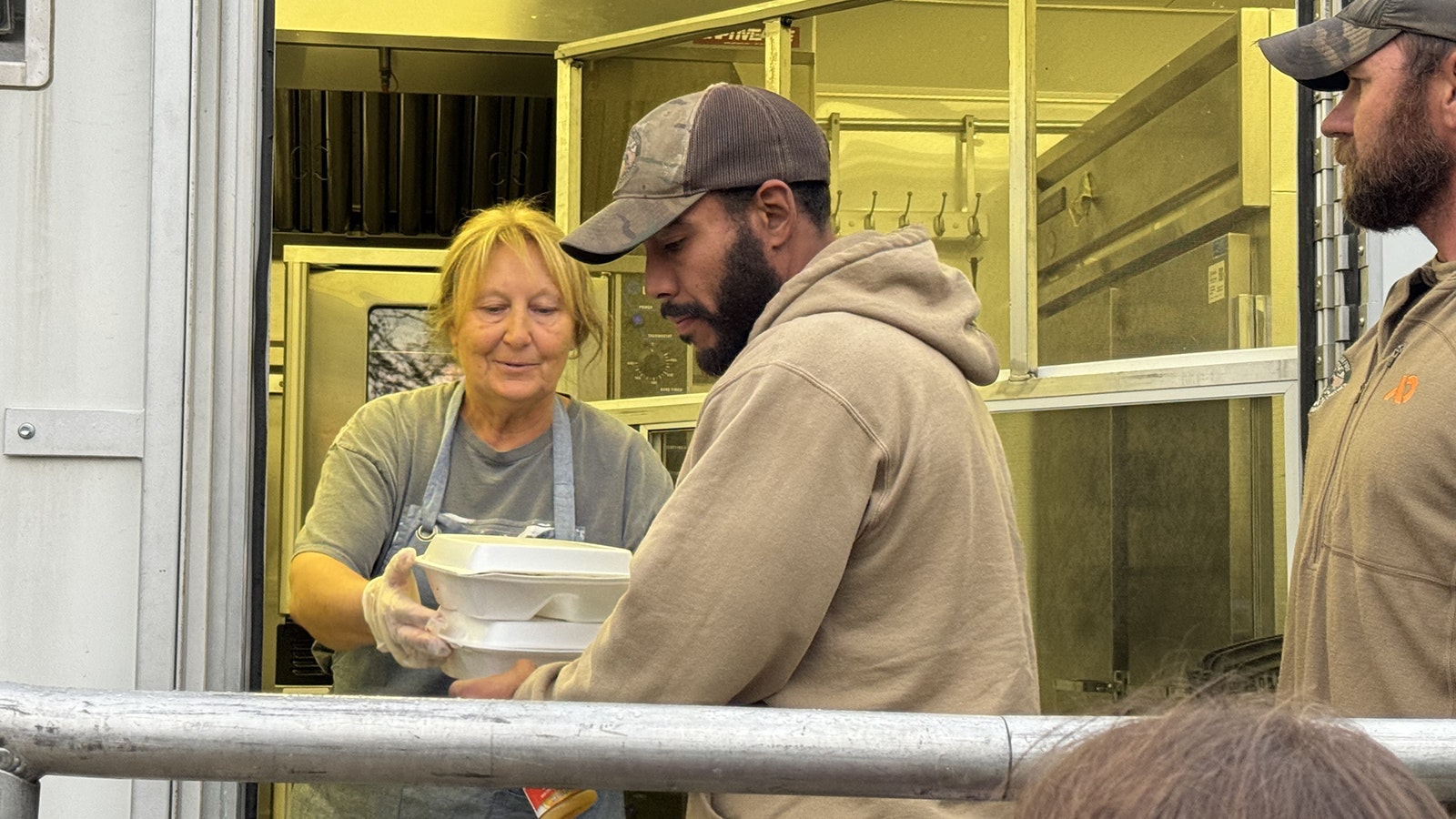 Sotomayor and Merritt receive their dinners at base camp on the Clearwater Fire in northwest Wyoming.