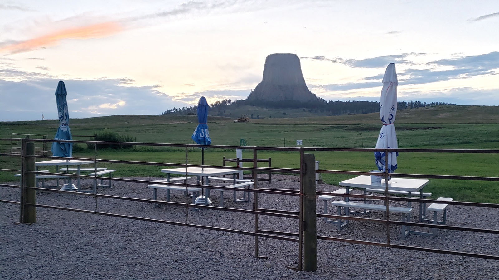 Outdoor seating with Devils Tower in the distance.