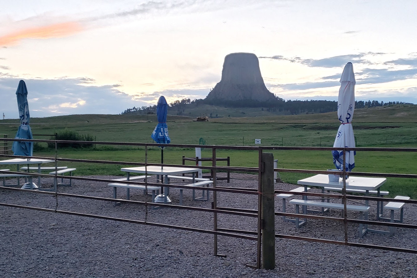 Outdoor seating with Devils Tower in the distance.
