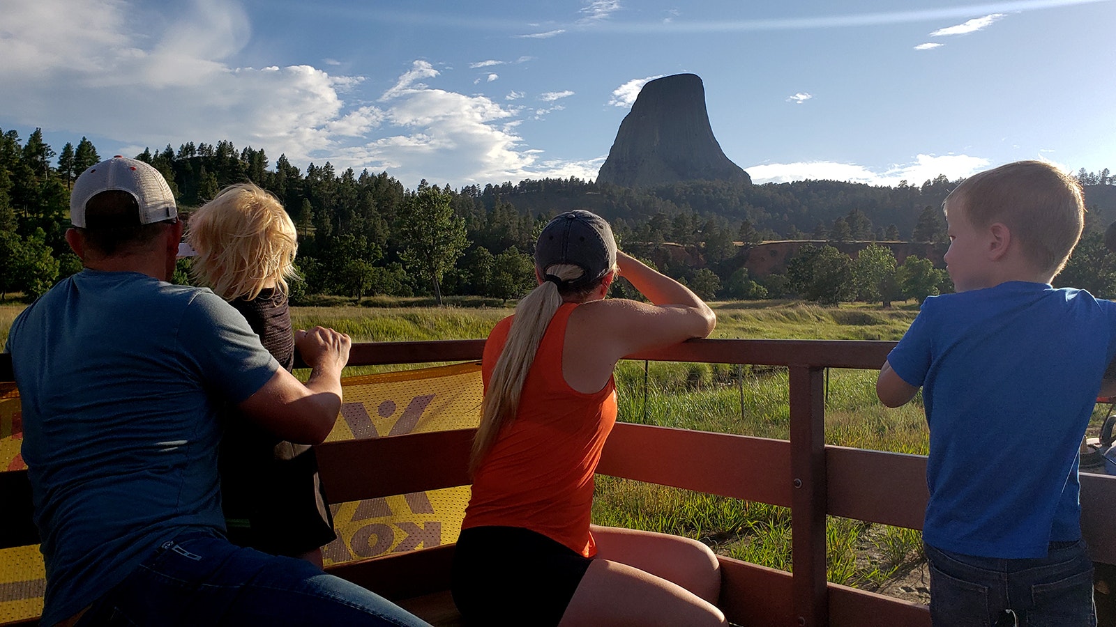 Participants on a hayride around the Campstool Ranch marvel at the distant Devils Tower, which can be seen from many angles during the hayride.