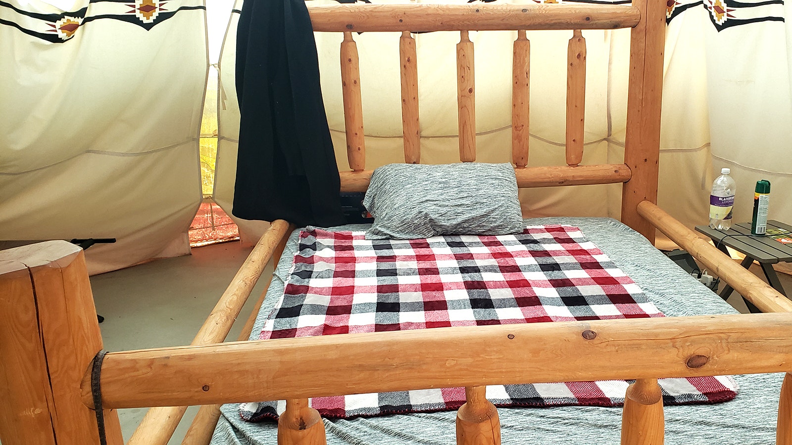 The teepees at the Devils Tower KOA come with beds, but campers must bring their own linens and anything else they want, like the small foldable table to the right of the bed.