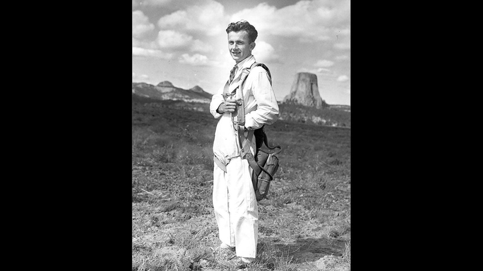 George Hopkins strikes a pose with Devils Tower in the background. He successfully parachuted on top of it on Oct. 1, 1941.