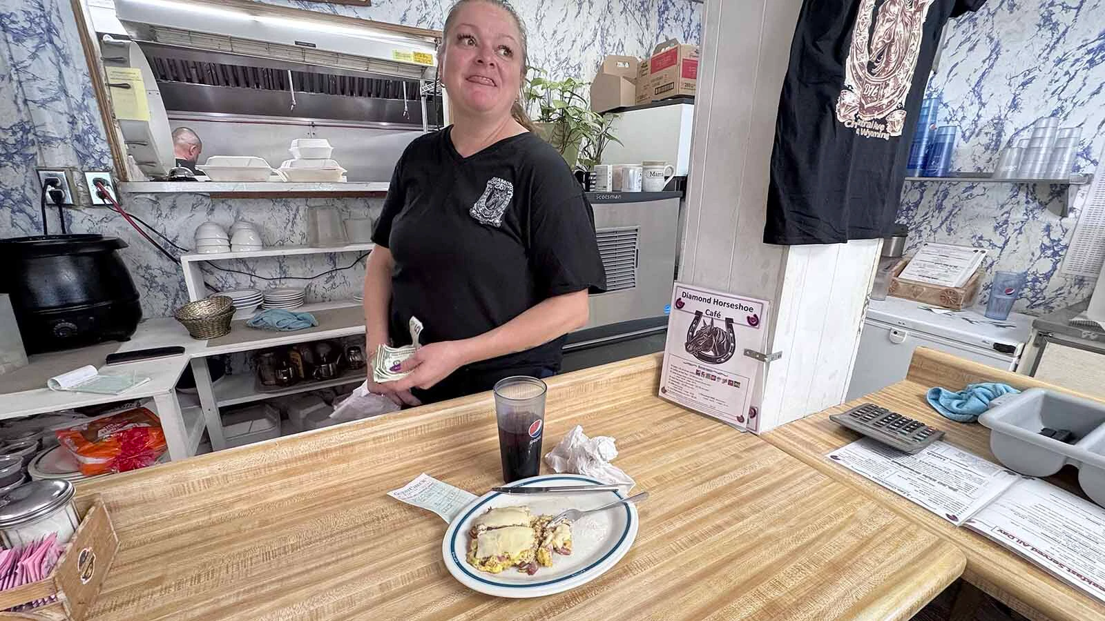 Kendra Scott at the Diamond Horseshoe Café in south Cheyenne picks up a tip left by a diner on a busy Sunday morning.