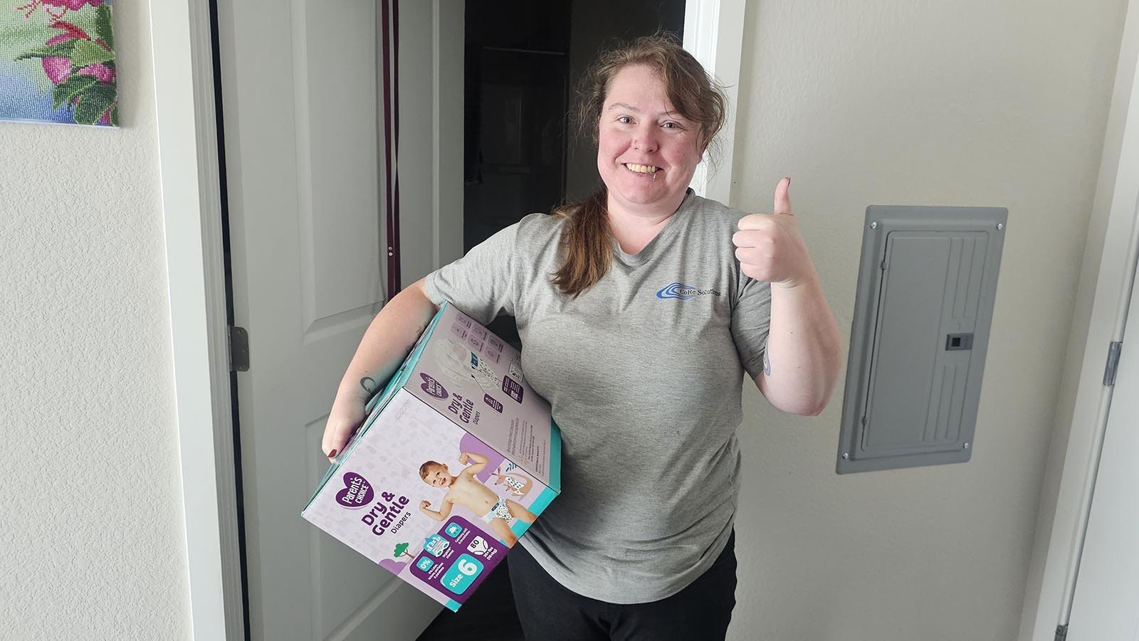 Harley Miller gives Cowboy State Daily a thumbs up. She's impressed with the Wyoming community in Cheyenne, which banded together to help her find the missing box of diapers she'd ordered for her son.