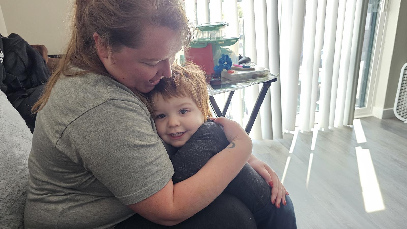 Harley Miller gives her son, Conor Zaklan a hug. Miller and her husband, Josh Zaklan, have recently moved to Wyoming.