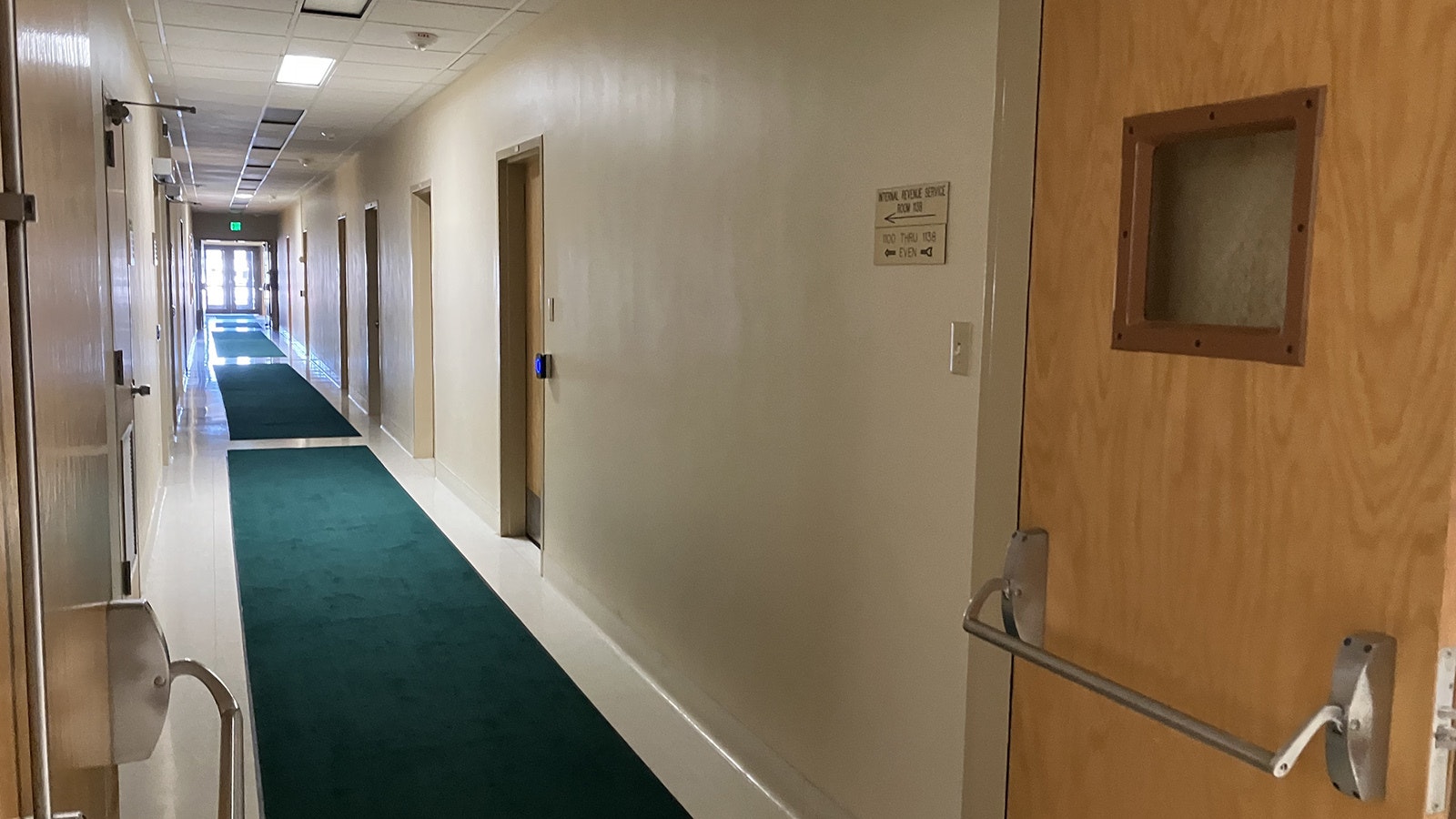 An interior first-floor hallway in the building was vacant and quiet on Wednesday morning. The building hosts at least 15 different federal agencies and offices.