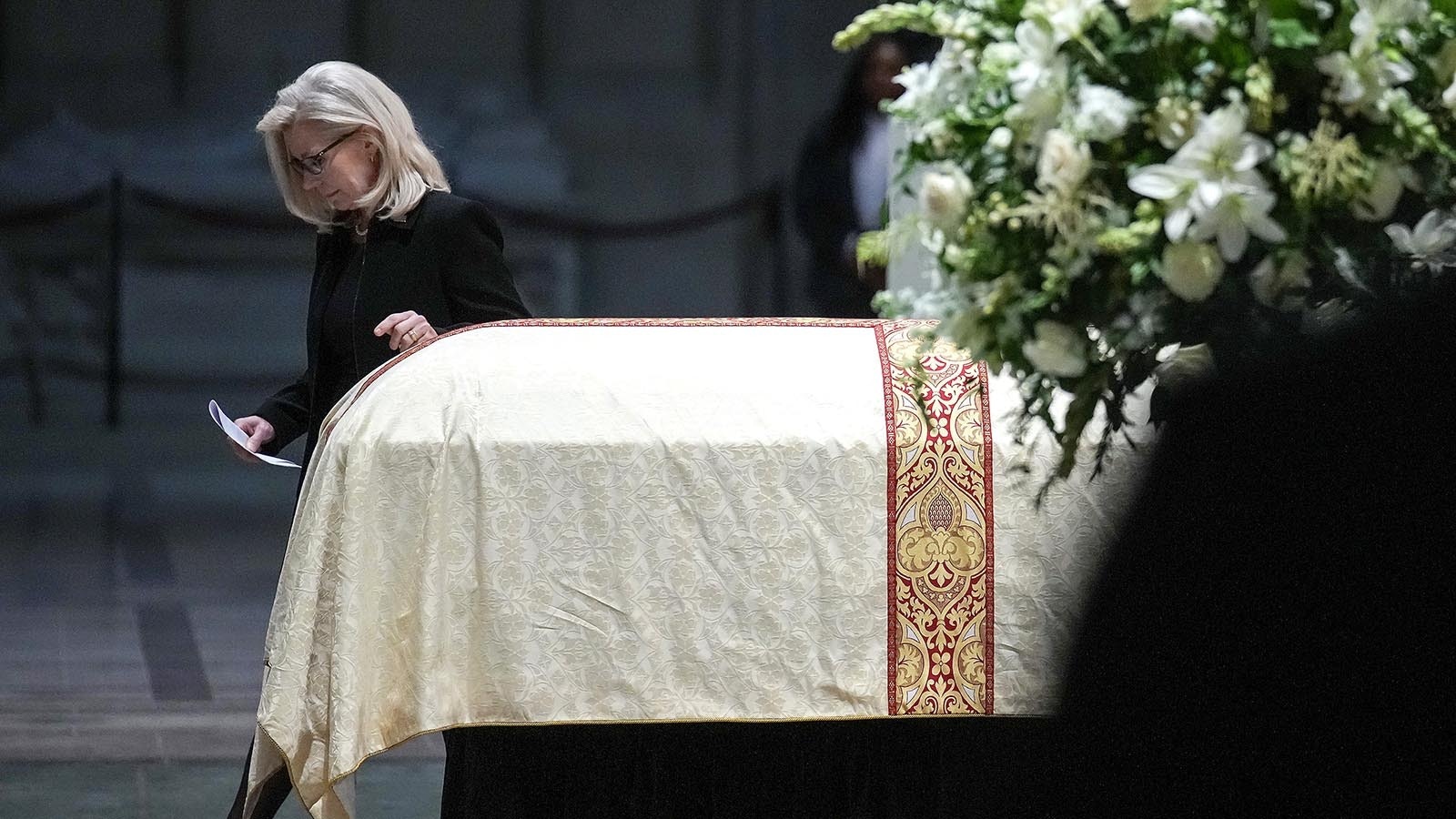 Former Rep. Liz Cheney, the daughter of former Vice President Dick Cheney, walks past her father's casket at Cheney's funeral service at the National Cathedral on Nov. 20, 2025. in Washington, D.C.