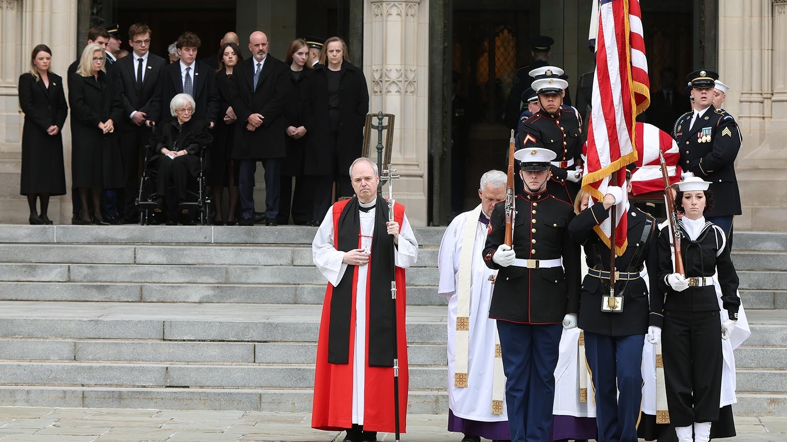 U.S. military body bearers carry the casket containing the remains of former Vice President Dick Cheney out of the National Cathedral as members of the Cheney family watch, during Cheney's funeral service on Nov. 20, 2025, in Washington, D.C.