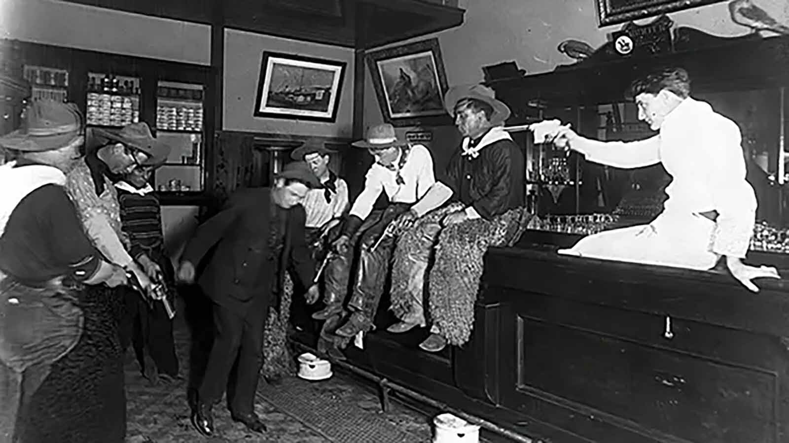 Patrons appear to be compelling a man to dance in this saloon photo believed to have been taken in Wyoming at an unspecified saloon in the 1880s.