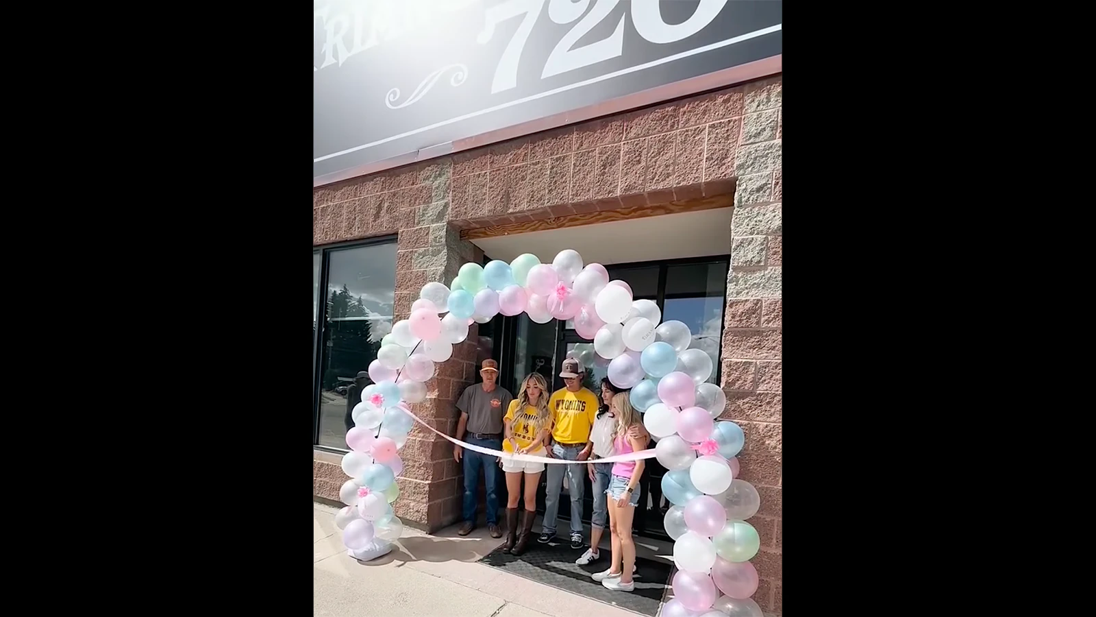 The Pollard family, who include 3 Zero 7 Place owners Rick, left, Michelle, second from right, and daughter, Aspen, with scissors, celebrate the opening of their soda shop in Kemmerer.